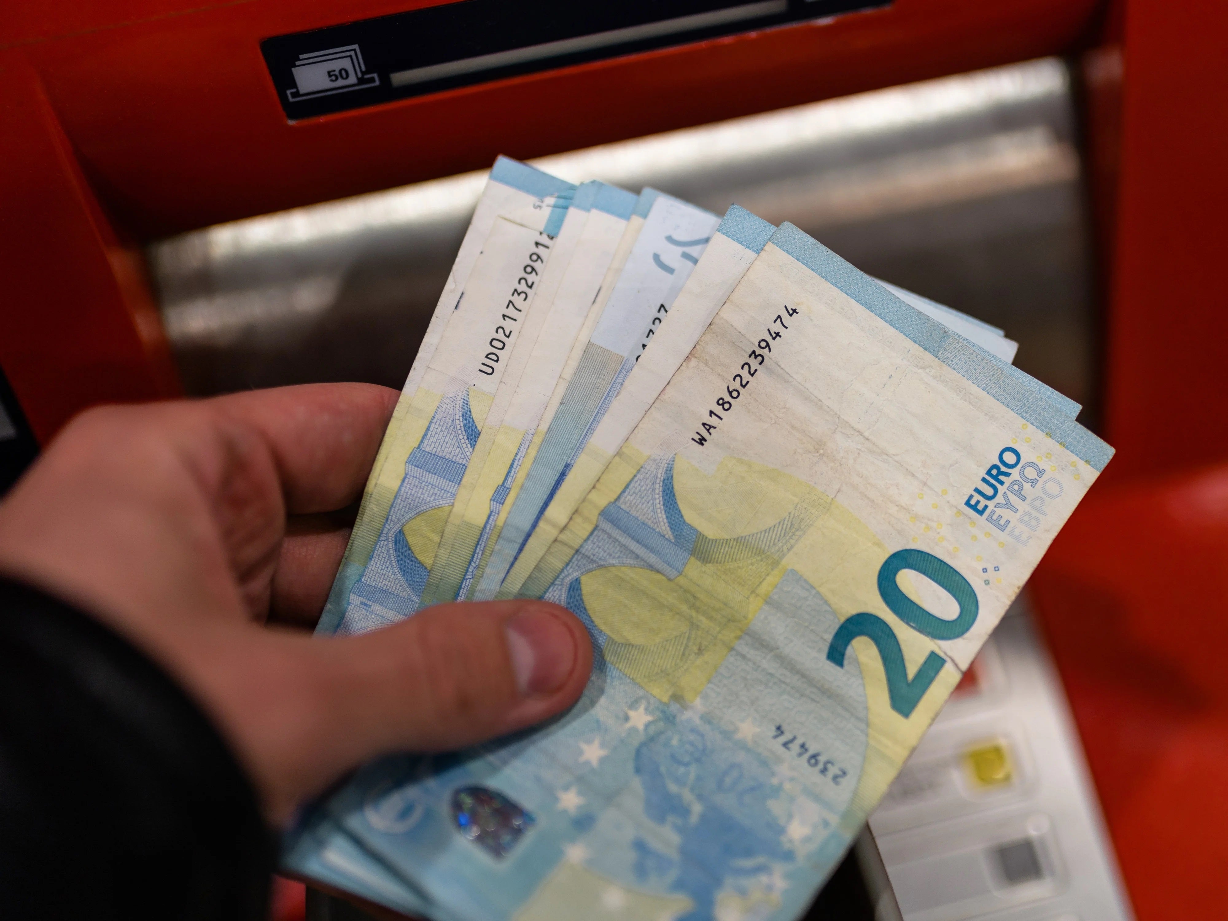 Euro-Geld vor dem Geldautomaten einer Bank