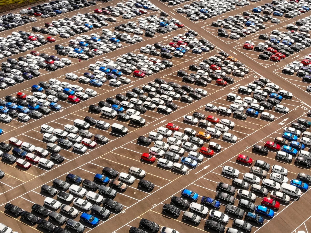 Many cars photographed from a bird's eye view in a parking lot.