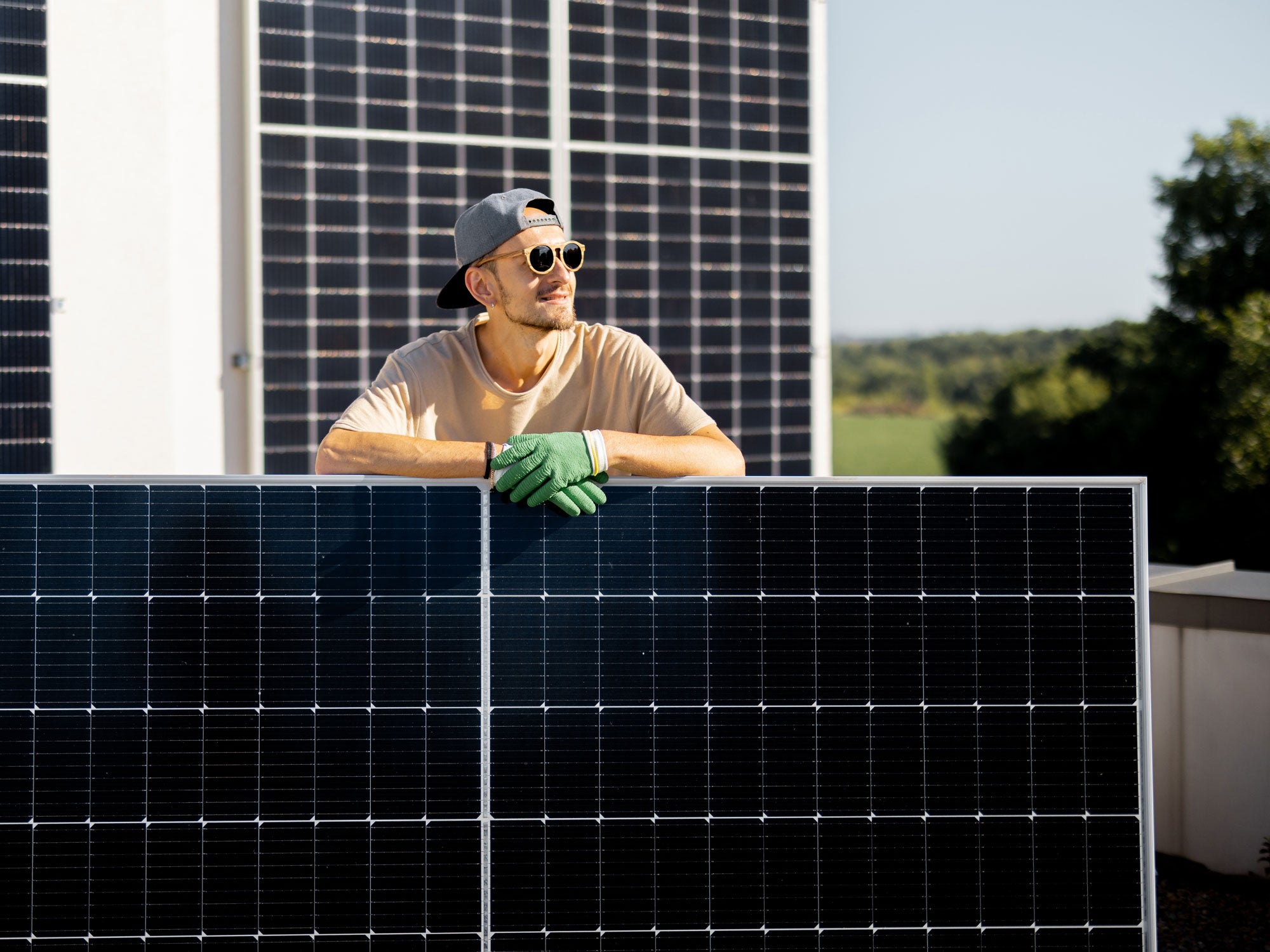 Ein Mann montiert mehrere Solar-Anlagen
