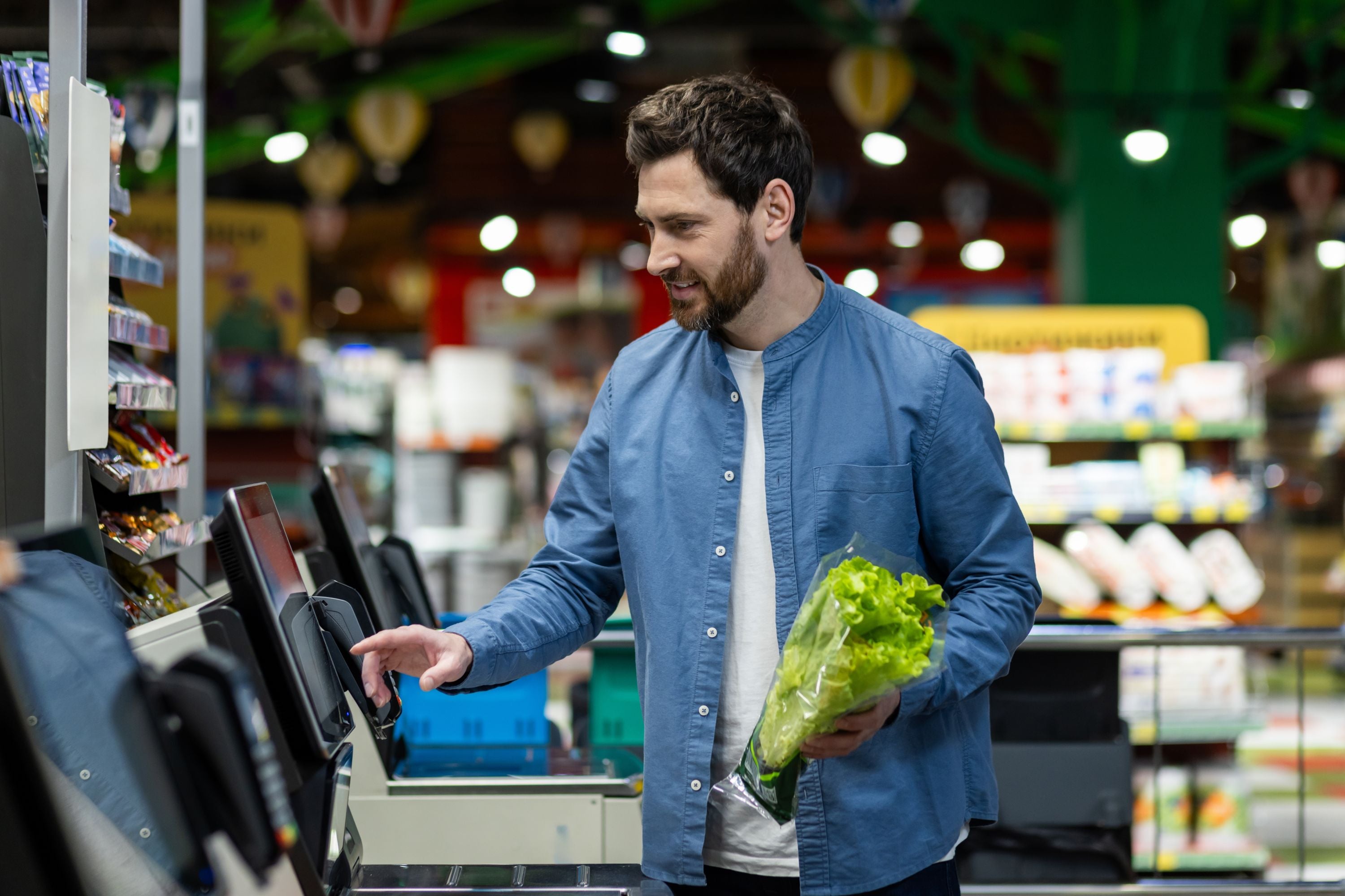 Ein Mann steht an einer Supermarktkasse